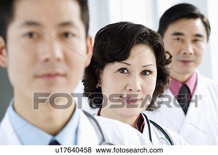 Portrait of two male doctors with a female doctor View Large Photo Image Stock Photo - Portrait of two male doctors with a female doctor. Fotosearch