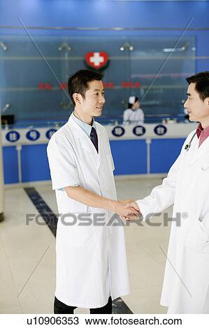 Close-up of two male doctors shaking hands View Large Photo Image Stock Image - Close-up of two male doctors shaking hands. Fotosearch