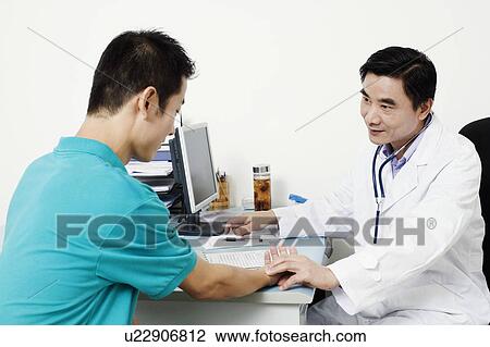 Male doctor checking a patient's pulse View Large Photo Image Stock Image - Male doctor checking a patient's pulse. Fotosearch