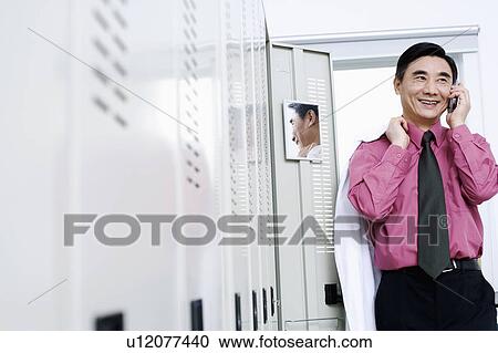 Male doctor talking on a mobile phone View Large Photo Image Stock Image - Male doctor talking on a mobile phone. Fotosearch