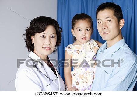 Stock Photo - Portrait of a female doctor a girl child and a young man smiling. Fotosearch