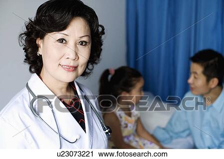 Stock Image - Portrait of a female doctor smiling. Fotosearch