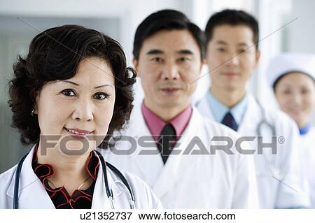 Stock Photo - Portrait of three doctors with a nurse. Fotosearch