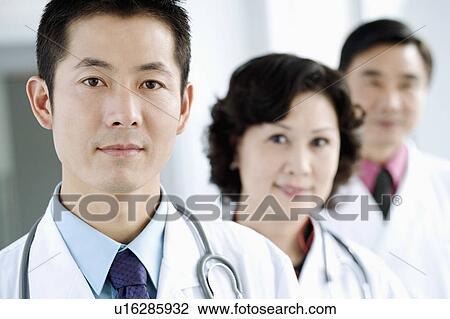 Portrait of two male doctors with a female doctor View Large Photo Image Stock Image - Portrait of two male doctors with a female doctor. Fotosearch