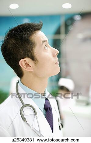 Side profile of a doctor with a stethoscope around his neck View Large Photo Image Stock Image - Side profile of a doctor with a stethoscope around his neck. Fotosearch