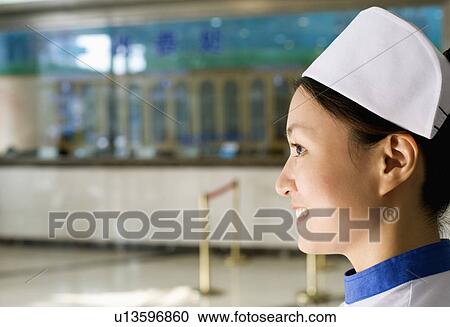 Side profile of a female nurse smiling View Large Photo Image Stock Image - Side profile of a female nurse smiling. Fotosearch