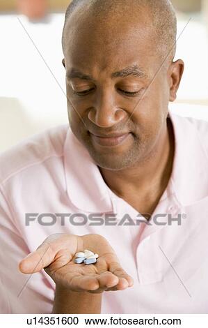 Stock Image - Man Taking Pills. Fotosearch