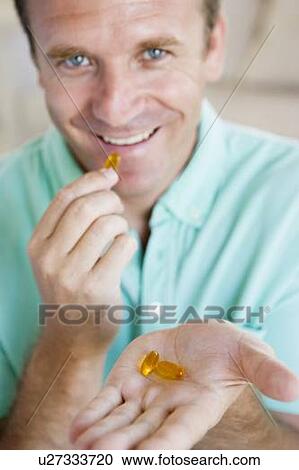 Stock Image - Man Taking Pills. Fotosearch