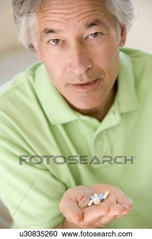 Stock Image - Man Taking Pills. Fotosearch