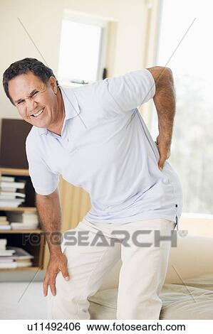 Stock Photograph - Man With Back Pain. Fotosearch