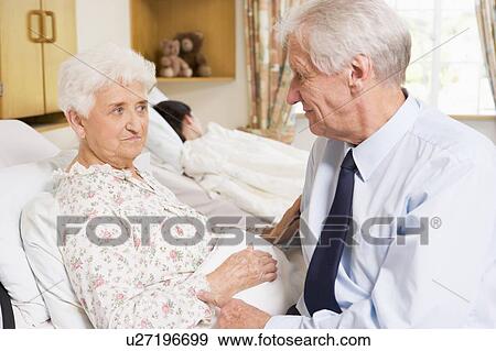 Senior Man Sitting With His Wife In Hospital View Large Photo Image Stock Photo - Senior Man Sitting With His Wife In Hospital. Fotosearch