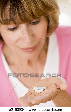 Stock Image - Woman Taking Pills. Fotosearch