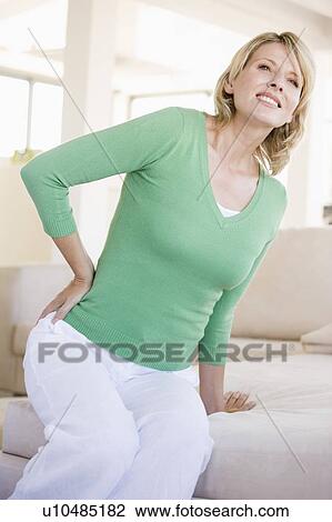 Stock Image - Woman With Back Pain. Fotosearch