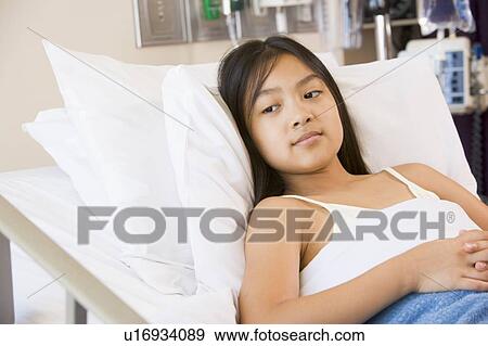 Stock Photo - Young Girl Lying In Hospital Bed. Fotosearch
