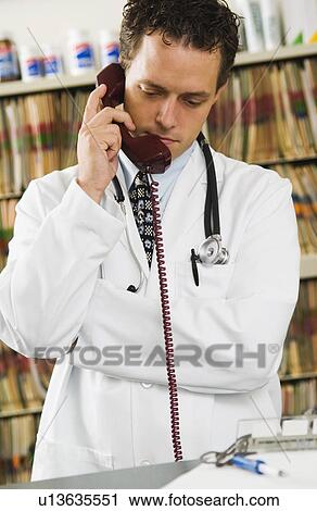 Stock Image - Doctor on telephone. Fotosearch