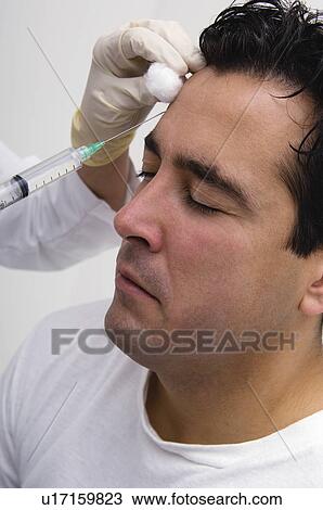 Stock Image - Man getting botox. Fotosearch