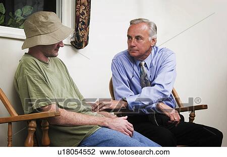Stock Image - Man receiving counseling. Fotosearch