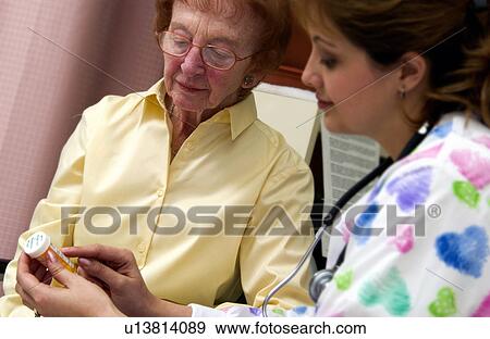 Nurse giving senior woman a bottle of pills View Large Photo Image Stock Photo - Nurse giving senior woman a bottle of pills. Fotosearch