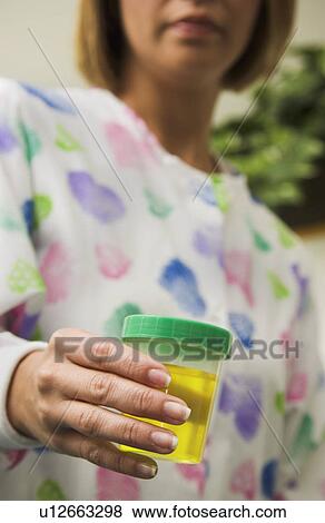 Stock Photo - Nurse with urine specimen. Fotosearch