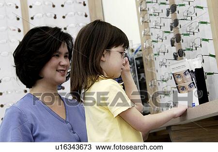 Asian mom and daughter choosing eyeglasses View Large Photo Image Stock Image - Asian mom and daughter choosing eyeglasses. Fotosearch