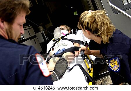 Stock Photography - EMTs loading patient into ambulance. Fotosearch