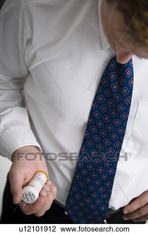 Man looking at prescription bottle View Large Photo Image Stock Image - Man looking at prescription bottle. Fotosearch