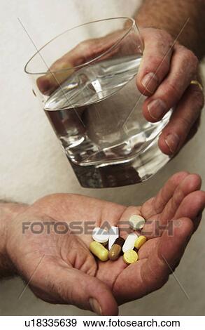 Stock Photo - Man taking pills. Fotosearch