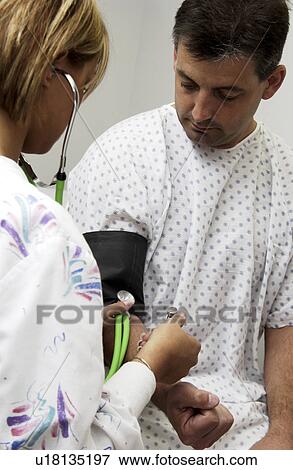 Nurse taking patients blood pressure View Large Photo Image Stock Photo - Nurse taking patients blood pressure. Fotosearch