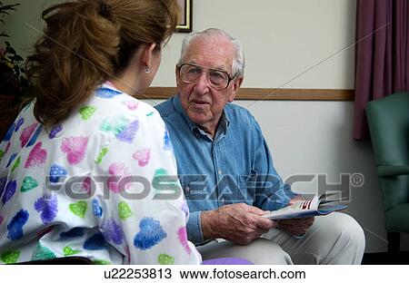 Nurse talking with senior man View Large Photo Image Stock Image - Nurse talking with senior man. Fotosearch