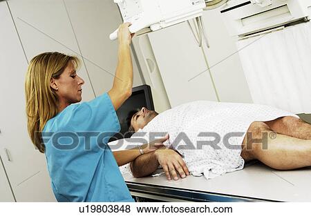 Stock Photo - Patient having an xray taken. Fotosearch