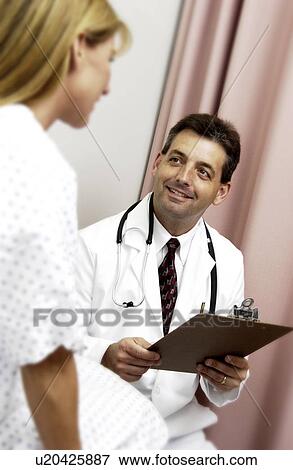 Physician consulting with patient View Large Photo Image Stock Photo - Physician consulting with patient. Fotosearch