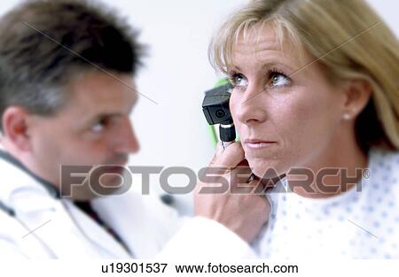 Physician examining patient View Large Photo Image Stock Photo - Physician examining patient. Fotosearch