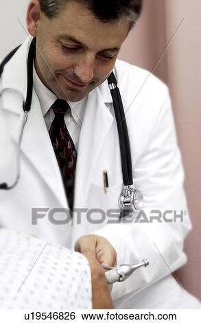 Physician examining patient View Large Photo Image Stock Photograph - Physician examining patient. Fotosearch