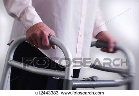 Senior woman walking with walker View Large Photo Image Stock Image - Senior woman walking with walker. Fotosearch