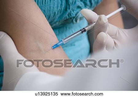 Stock Photography - Woman getting a shot. Fotosearch