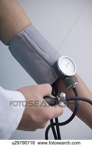 Woman having blood pressure taken View Large Photo Image Stock Photograph - Woman having blood pressure taken. Fotosearch
