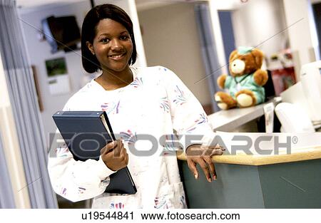 Stock Image - African American nurse at nurses station. Fotosearch