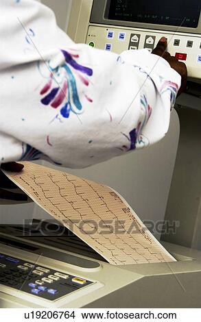 Picture - African American technician monitoring EKG machine. Fotosearch