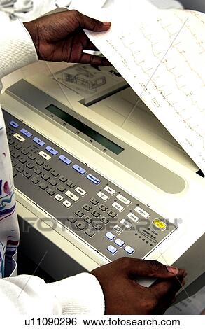 Stock Photograph - African American technician monitoring EKG machine. Fotosearch