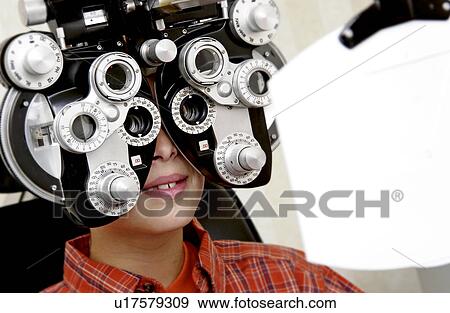 Boy getting eye exam View Large Photo Image Stock Photo - Boy getting eye exam. Fotosearch