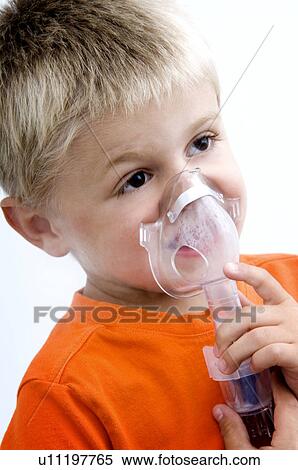 Stock Photography - Boy using breathing machine. Fotosearch