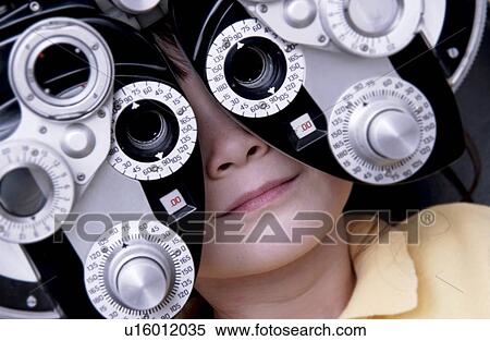 Stock Photography - Girl getting vision tested. Fotosearch