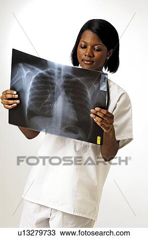 Stock Image - Medical staff reading xrays. Fotosearch