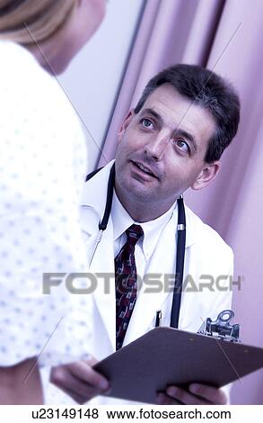 Physician consulting with patient View Large Photo Image Stock Photo - Physician consulting with patient. Fotosearch