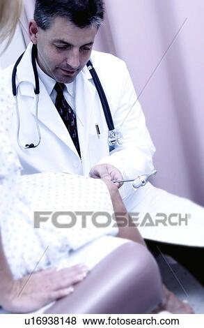Stock Photo - Physician examining patient. Fotosearch