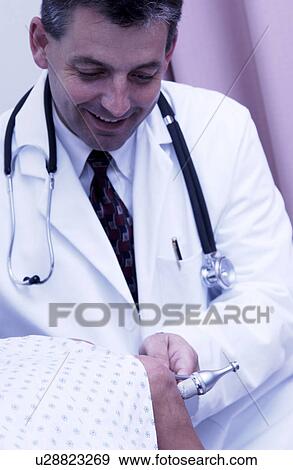 Physician examining patient View Large Photo Image Stock Photo - Physician examining patient. Fotosearch