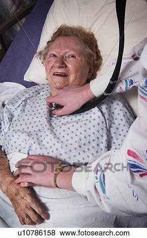 Stock Photo - Senior woman sick in bed. Fotosearch