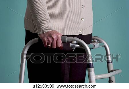 Senior woman walking with walker View Large Photo Image Stock Photo - Senior woman walking with walker. Fotosearch