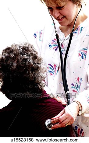 Stock Photo - Woman having a medical checkup. Fotosearch