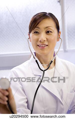A female doctor examining patient with stethoscope View Large Photo Image Stock Image - A female doctor examining patient with stethoscope. Fotosearch